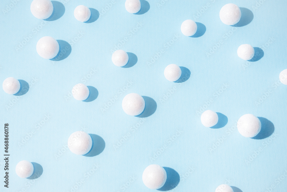 Snowballs on pastel blue background. New Year and Christmas idea. Minimal abstract winter holidays concept. Copy space.