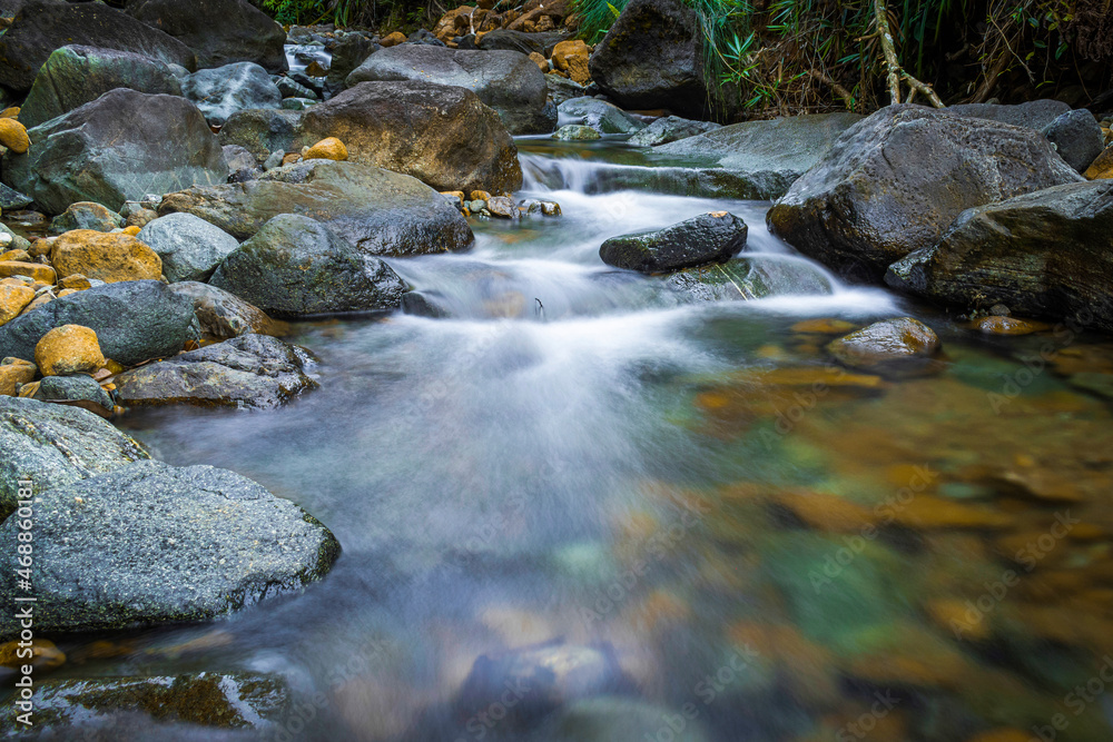 slow shutter speed of soft water and rocks river in jungle slow shutter speed of soft water and rocks river in jungle