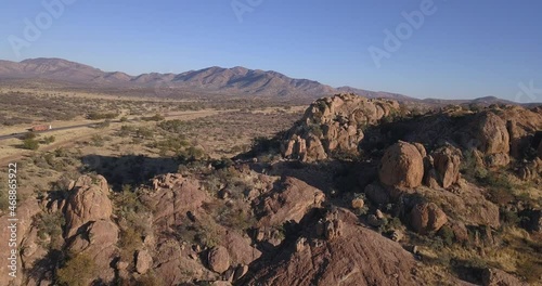 4K aerial drone video of African savanna hills, large red granite boulders range near B1 highway south of Windhoek in central highland Khomas Hochland of Namibia, southern Africa photo