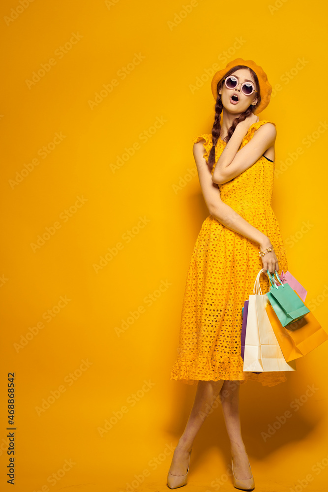 smiling woman in a yellow hat Shopaholic fashion style isolated background smiling woman in a yellow hat Shopaholic fashion style isolated background
