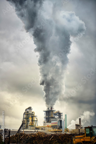 industrial lumber factory pouring smoke into the atmosphere. Concept for global warming