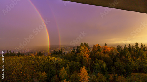 Double rainbow over Fraser Valley, BC, late afternoon in early winter as seen from Burnaby Mountain.