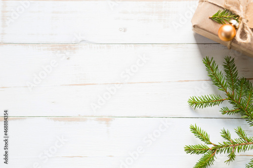 Gift box for Christmas and new year in eco-friendly materials  kraft paper  live fir branches  cones  twine. Tags with mock up  natural decor  hand made  DIY. Flatly  background  frame  Minimalism