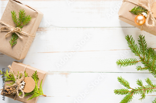 Gift box for Christmas and new year in eco-friendly materials: kraft paper, live fir branches, cones, twine. Tags with mock up, natural decor, hand made, DIY. Flatly, background, frame, Minimalism