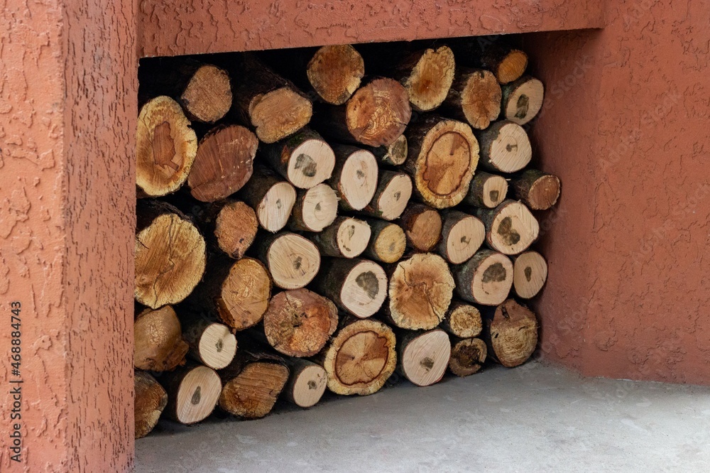 A neatly stacked woodpile cooked next to the oven