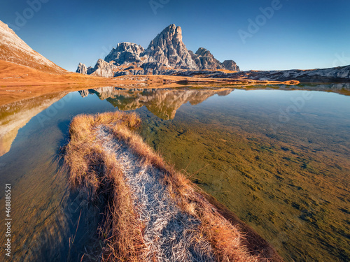 Schusterplatte peak reflected in the Calm waters of Piani lake. Sunny autumn view of Dolomite alps. Majestic morning scene of Tre Cime Di Laveredo National Park, Italy, Europe. photo