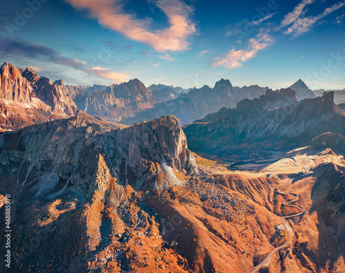 Fototapeta Naklejka Na Ścianę i Meble -  Aerial view from flying drone of winding Giau pass road with Ra Gusela peak. Fantastic autumn scene of Dolomite Alps, Belluno province, Italy, Europe. Traveling concept background.