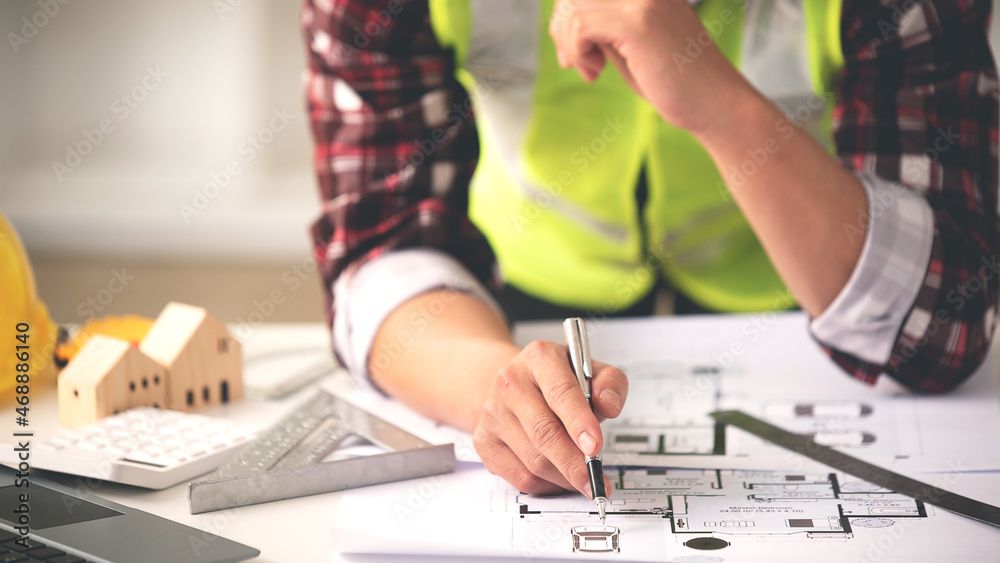 architect concept, working architect with blueprints in office to present to customers architect concept, working architect with blueprints in office to present to customers