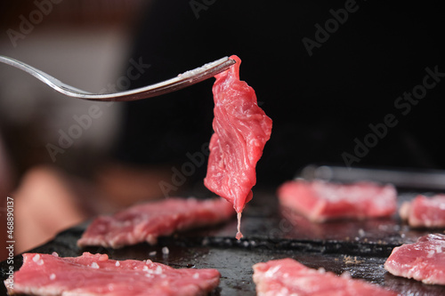 Hot stone grilled meat preparation.
