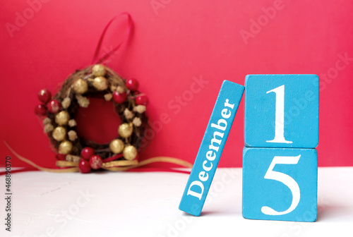 Wall Mural December 15th, Wooden calendar showing date on 15 December and Christmas wreath on the table