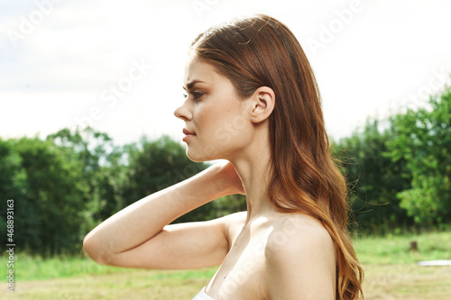 portrait of a woman attractive look bare shoulders green leaves cropped view