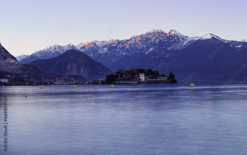 characteristic landscape of Lake Maggiore and the islands, cold winter tones on the surrounding snow-capped mountains