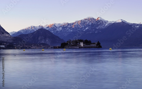 characteristic landscape of Lake Maggiore and the islands, cold winter tones on the surrounding snow-capped mountains