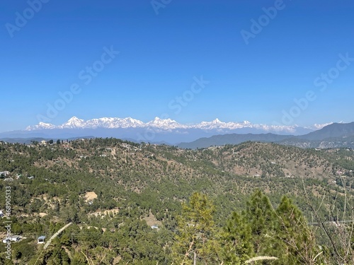 Mountains with green forest and snow