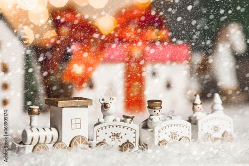 Happy New Year 2022. Beautiful background with a Christmas locomotive, snow and a gift. Celebrating the winter Christmas holidays. The concept of the beginning of the year.