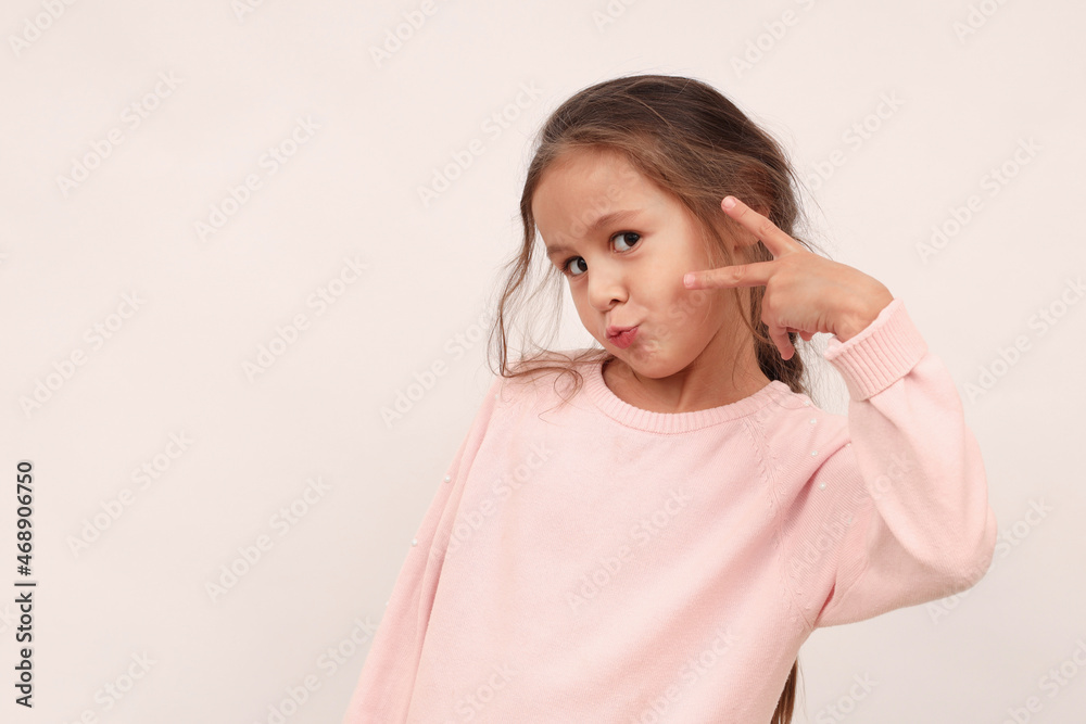 Lovely ambitious good-looking blond young girl child, feeling like super star, want become popular model, show peace sign victory gesture on eye, pouting silly and cute, look camera confident Lovely ambitious good-looking blond young girl child, feeling like super star, want become popular model, show peace sign victory gesture on eye, pouting silly and cute, look camera confident