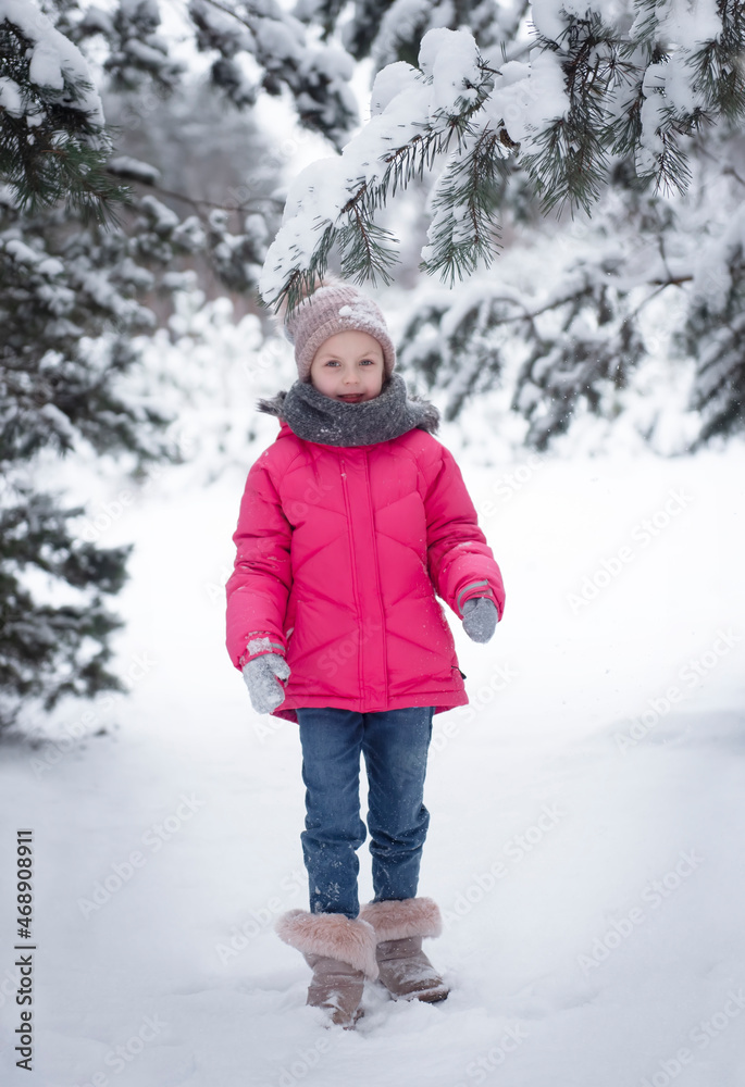 Child in winter. A little girl,  playing in the winter outside.