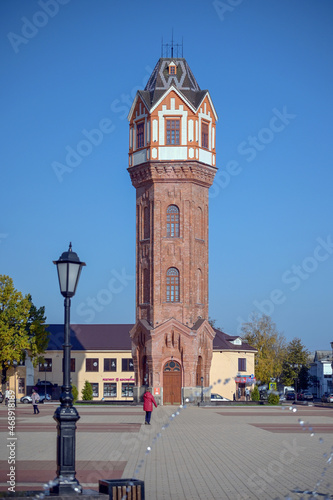 TA brick restored water tower in the Art Nouveau architectural style rises on the central square of the ancient city of Staraya Russa, Novgorod region.  Industrial architecture of the early XX century