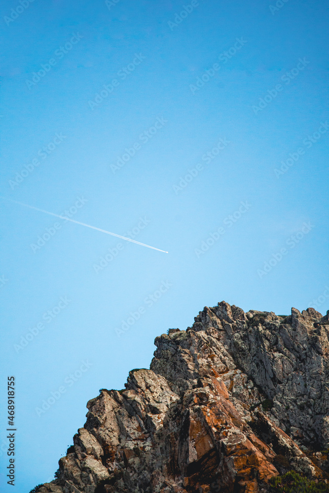 Fototapeta premium Airplane trail in the sky at Ursa beach, Portugal
