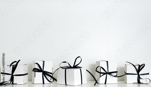 Black Friday sale with stylish gift box present and black ribbon on white background, flat lay, top view, copy space. Black friday concept. Shopping concept and black Friday composition.