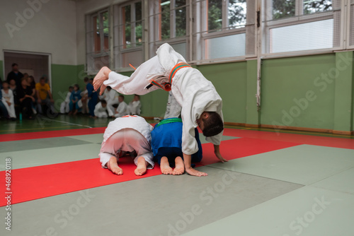 Two judo fighters showing technical skill while practicing martial arts in a fight club. The two fit men in uniform. fight, karate, training, arts, athlete, competition concept.Selective Focus