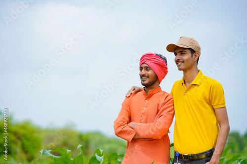 Indian agronomist with farmer at green agriculture field. © PRASANNAPIX