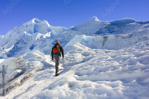 Mid-adult hiker on ice surface of melting Perito Moreno Glacier, Los Glaciares National Park, El Calafate, Patagonia, Argentina photo