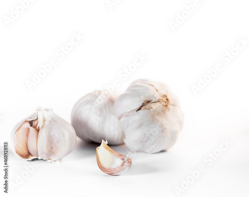 fresh organic garlic isolated over white background, full heads, cloves and peels, cooking ingredients. High quality photo