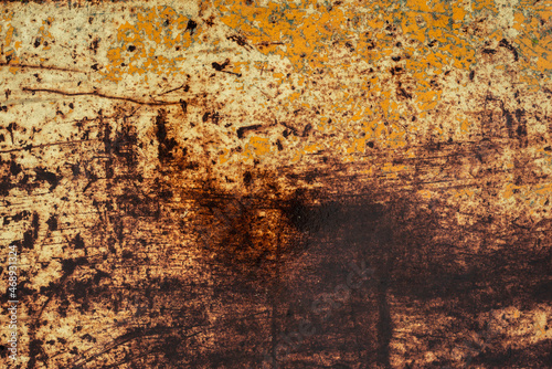 A rusted wet yellow and brown metal surface