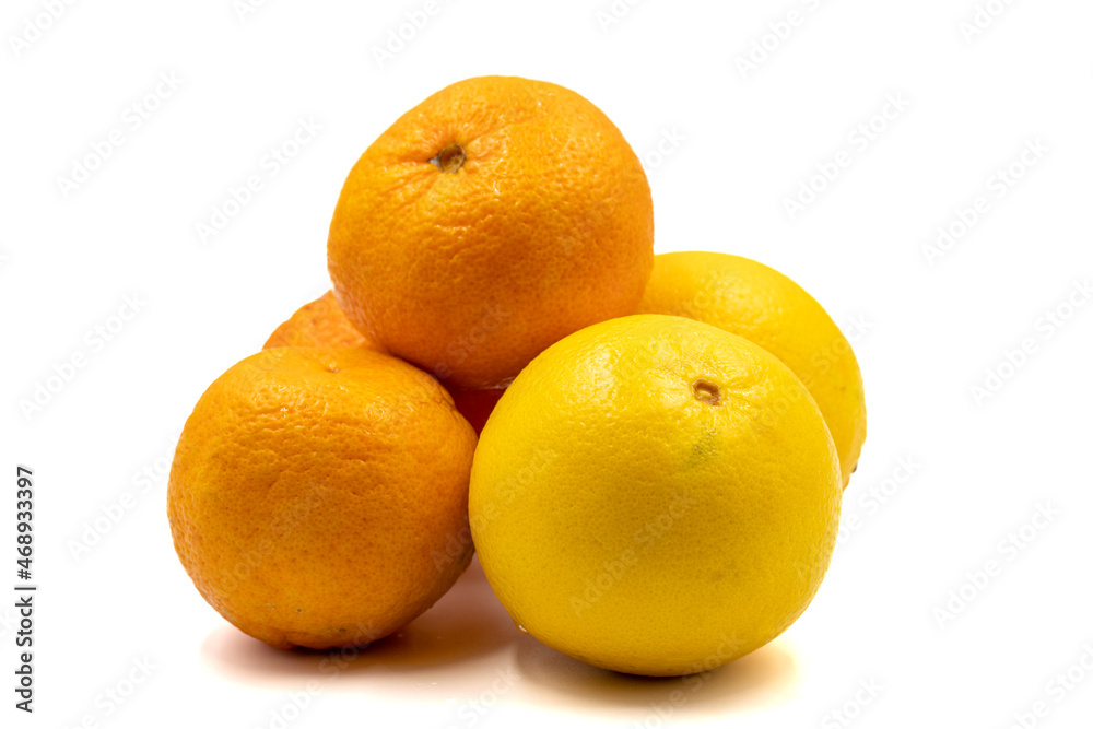 Ripe tangerines and oranges on a white background. Close-up Ripe tangerines and oranges on a white background. Close-up