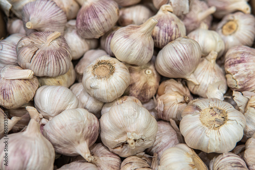 heads of fresh garlic on the counter in the supermarket