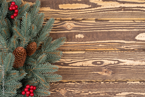 Christmas background with fir branches on wooden backdrop flat lay and top view. decoration with copy space.