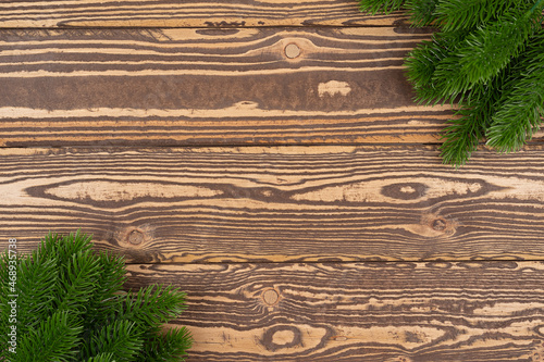 New Years background. Spruce branches on a wooden table. Ornaments for the New Year tree. Christmas concept