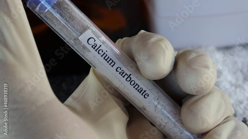 Calcium carbonate in test tube and black background