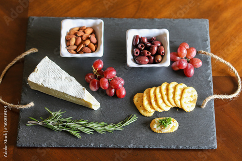 Cheese and cracker snack tray on slate board.