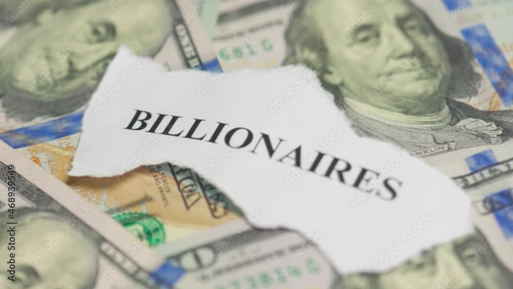 Billionaires income tax. Pile of us dollar banknotes and pieces of paper with Billionaires text. Billionaires income tax proposed in US Senat Billionaires income tax. Pile of us dollar banknotes and pieces of paper with Billionaires text. Billionaires income tax proposed in US Senat