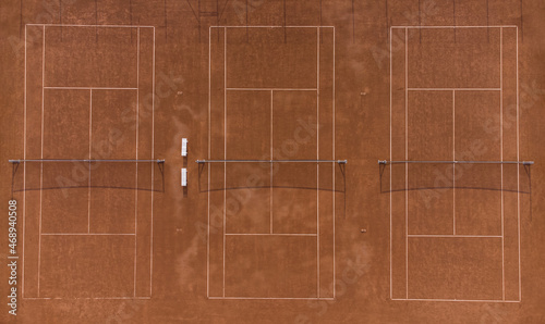 Gravel clay tennis courts seen from above. Drone aerial top down shot