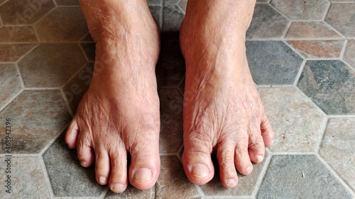 feet of old woman on the floor. Wrinkle skin.