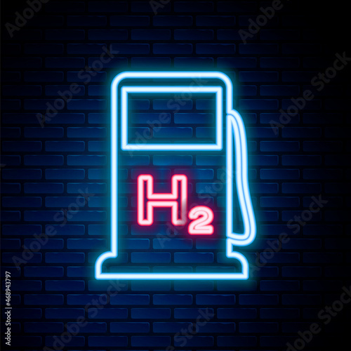 Glowing neon line Hydrogen filling station icon isolated on brick wall background. H2 station sign. Colorful outline concept. Vector