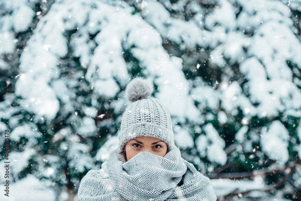 Beautiful young woman wearing scarf and a a hat on a cold winter day Beautiful young woman wearing scarf and a a hat on a cold winter day
