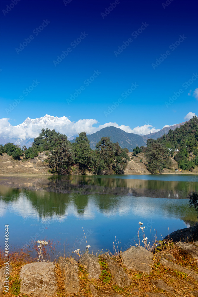 Deoria Tal , also Devaria or Deoriya is a high altitude lake in Uttarakhand, India. Blue sky with snow-covered mountains, Chaukhamba is one of them, in the background. Vertical image.