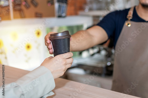Coffee Time. waiter staff or barista serving hot black coffee cup to female customer in cafe coffee shop  cafe restaurant  service mind  small business owner  takeaway food  food and drink concept
