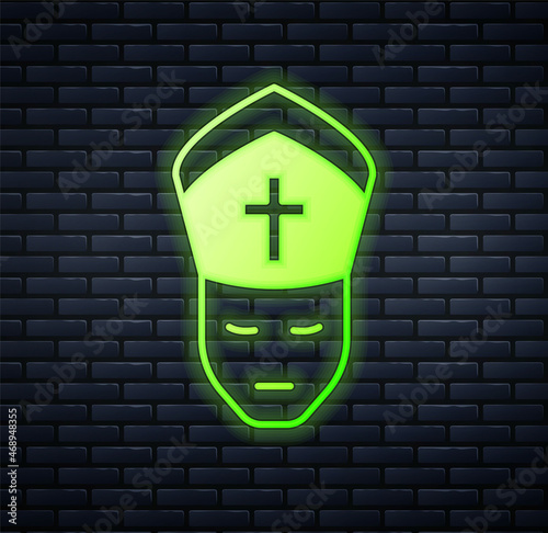 Glowing neon Pope icon isolated on brick wall background. Pope hat. Holy father. Vector