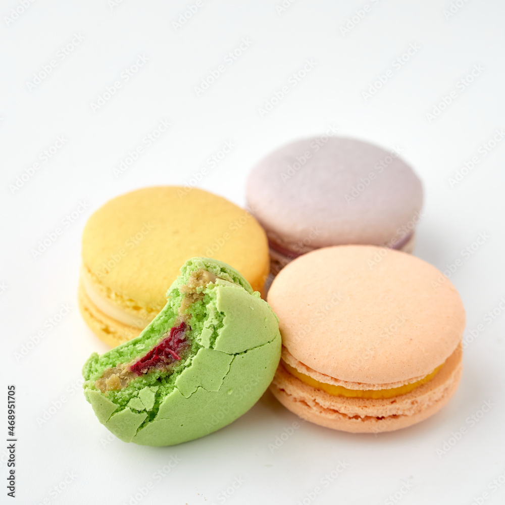 Colored pastries lie on a white background. Macaroons Colored pastries lie on a white background. Macaroons