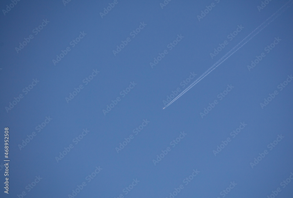 plane with chemtrails contrail, with blue sky plane with chemtrails contrail, with blue sky