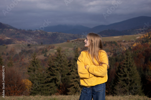 tourist girl standing at the meadow