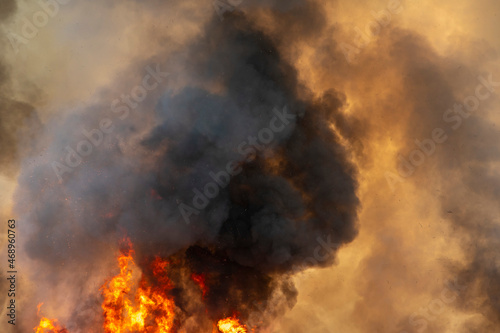 raging dust smoke pattern background of fire burn in grass fields, forests and black