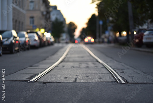 ending tramway rails on evening street in selective focus © Oleksandr