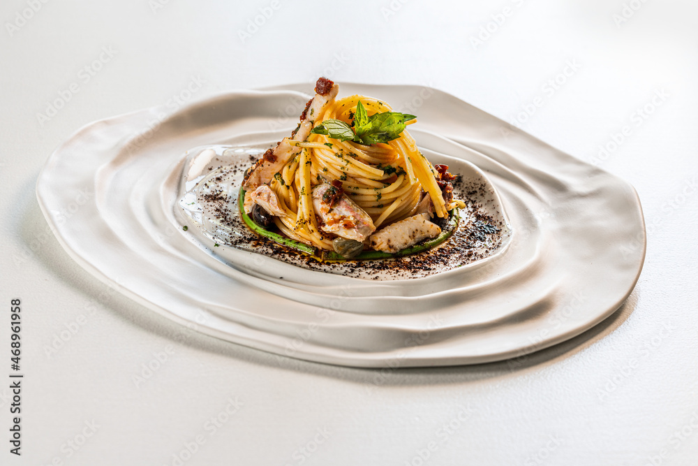 Spaghetti with red mullet, tomato, black garlic and olives, Tuscany, Italy, Europe Spaghetti with red mullet, tomato, black garlic and olives, Tuscany, Italy, Europe