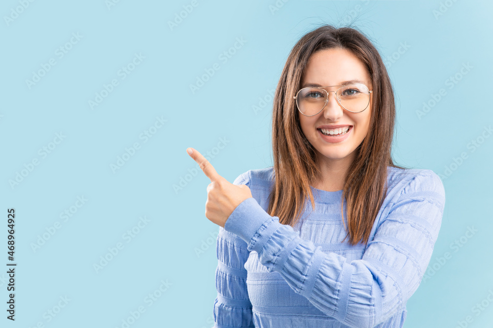 Young excited happy brunette woman pointing away and smile Young excited happy brunette woman pointing away and smile